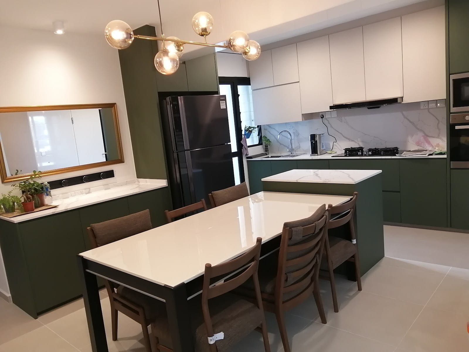 Project Zion at Tampines featuring custom dark stone kitchen island and sleek cabinetry